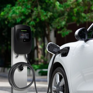 Focus closeup electric vehicle plugged in with EV charger device from blurred background of public charging station powered by renewable clean energy for progressive eco-friendly car concept.